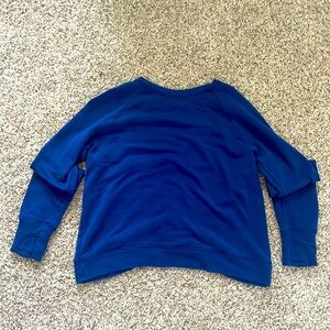 this is a long sleeve shirt, it is royal blue and has a cute slit in the back.